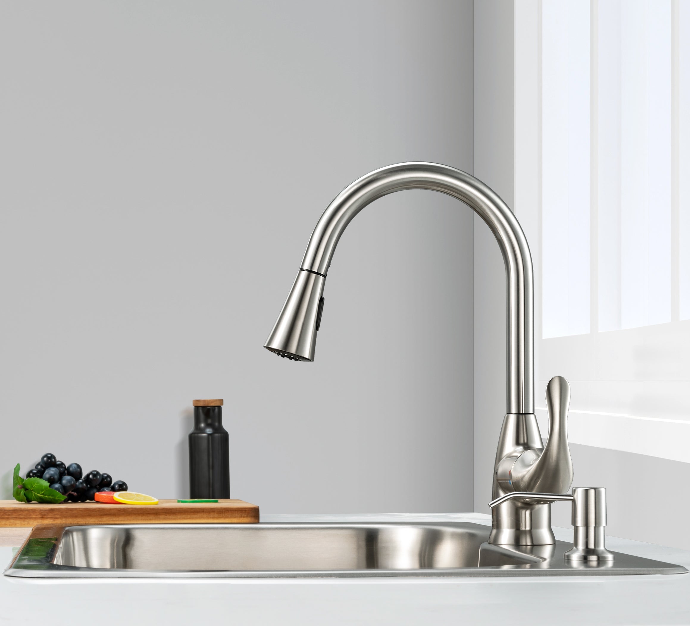 Stainless steel kitchen faucet and sink with a neutral background