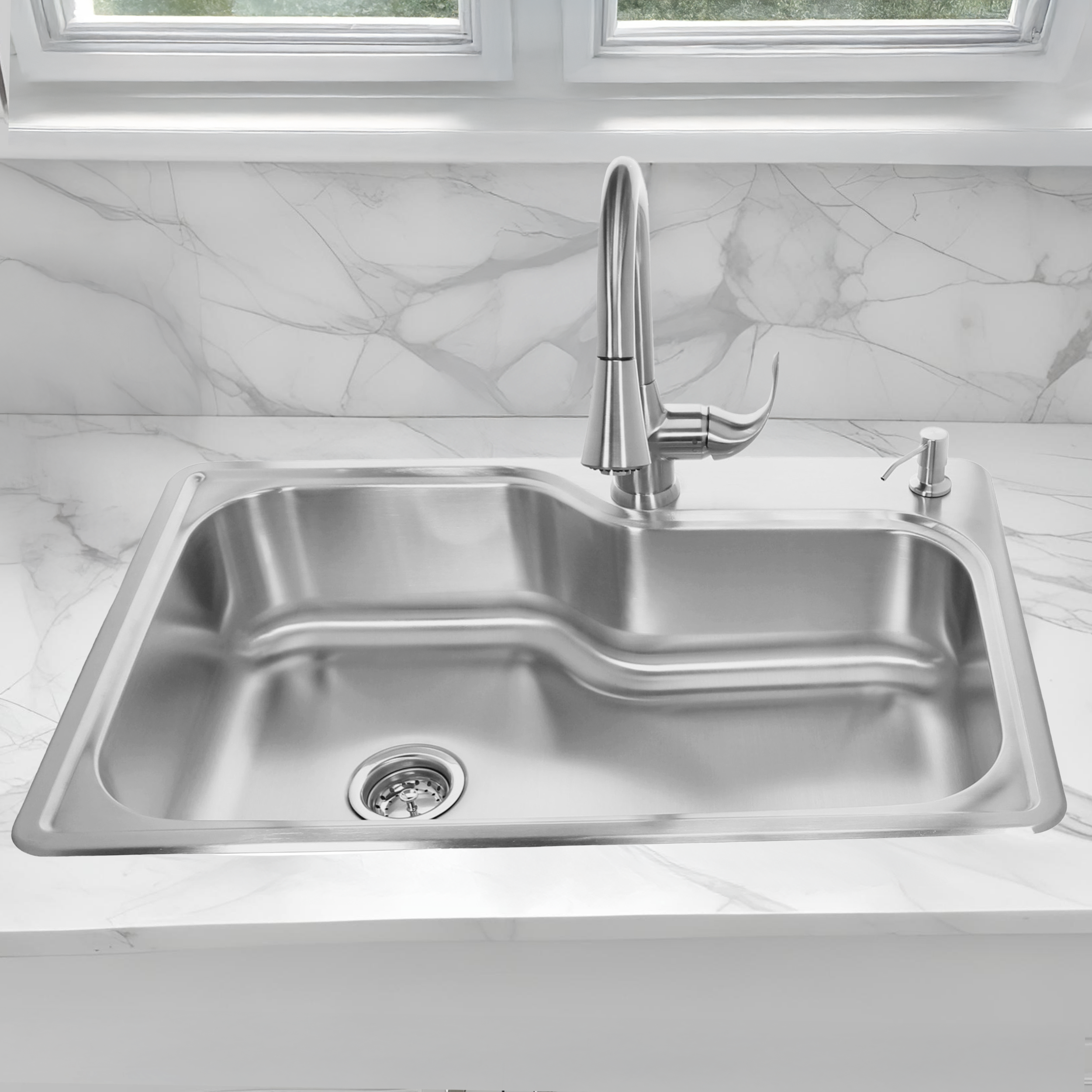 Stainless steel kitchen sink with faucet on a marble countertop