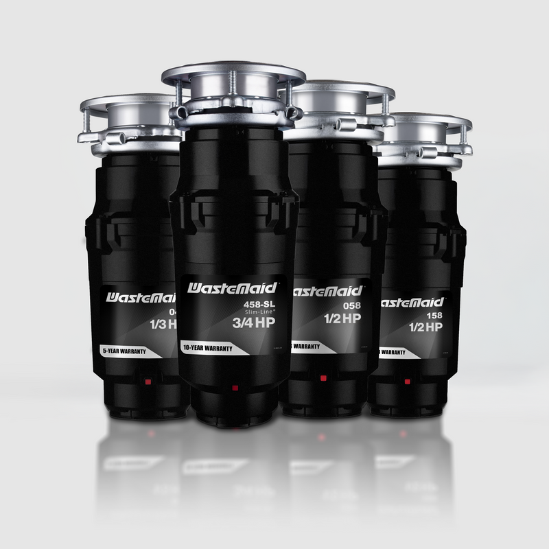 Four WasteMaid garbage disposals on a reflective surface with a light gray background